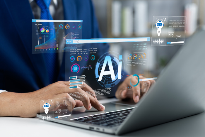 persona trabaja en computadora y sobre ella aparecen proyecciones de lo que ve en la computadora, con las siglas IA
