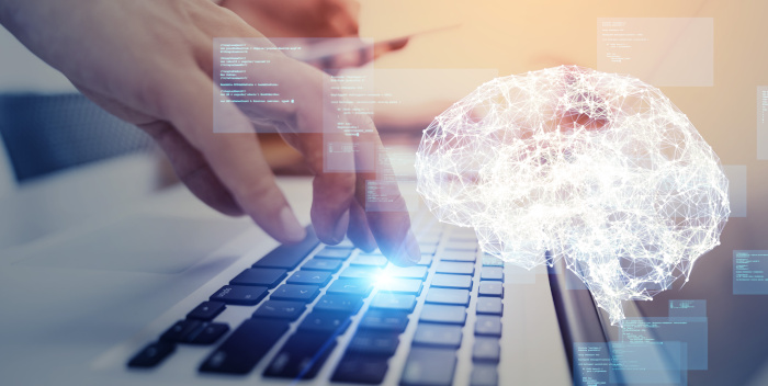 fotografía de un teclado de computadora con un sibujo de un cerebro hecho con puntos y líneas blancas que se conectan entre ellas