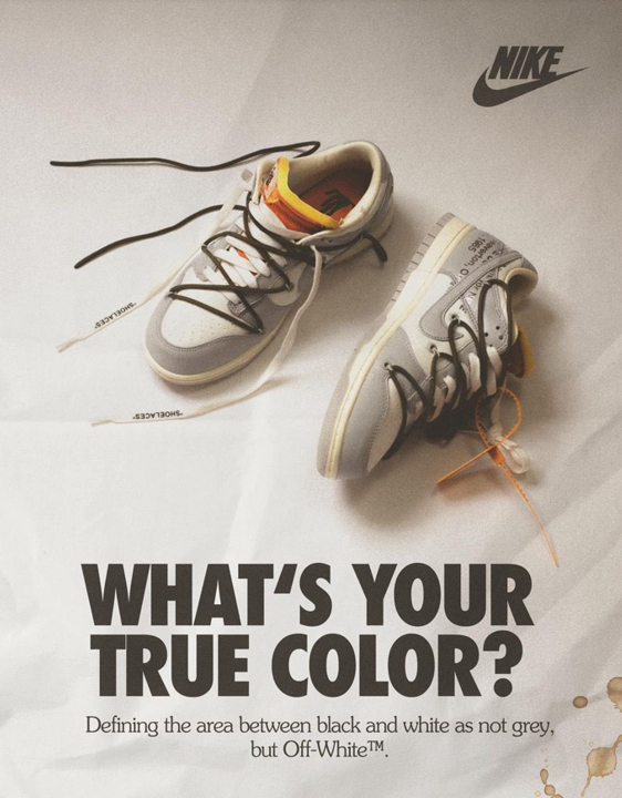Un par de tenis de marca Nike con los colores blanco, gris, negro y amarillo, con la frase “What’s your true color?”.